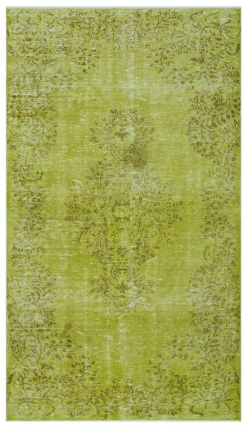 Load image 1 in gallery view. Chartreuse distressed rug with a faded brown floral medallion and border pattern on a white background.