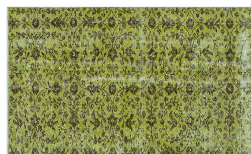 Load image 1 in gallery view. Chartreuse and dark brown vintage-style rug with a repeating floral medallion pattern and distressed texture.