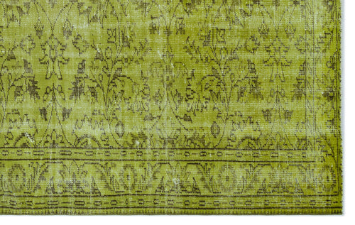 Load image 1 in gallery view. Chartreuse and brown distressed rug with a traditional floral medallion pattern and a detailed border.