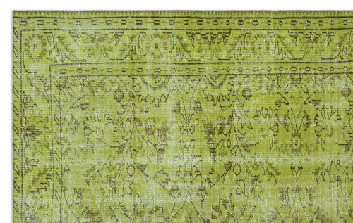 Load image 1 in gallery view. Chartreuse and brown vintage-style rug with a distressed floral medallion pattern and a geometric border.
