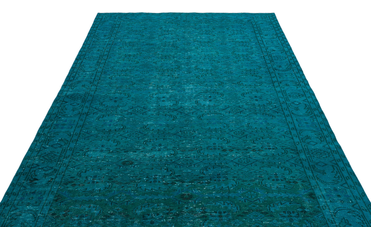 Teal distressed area rug with a traditional medallion and border pattern on a white background.