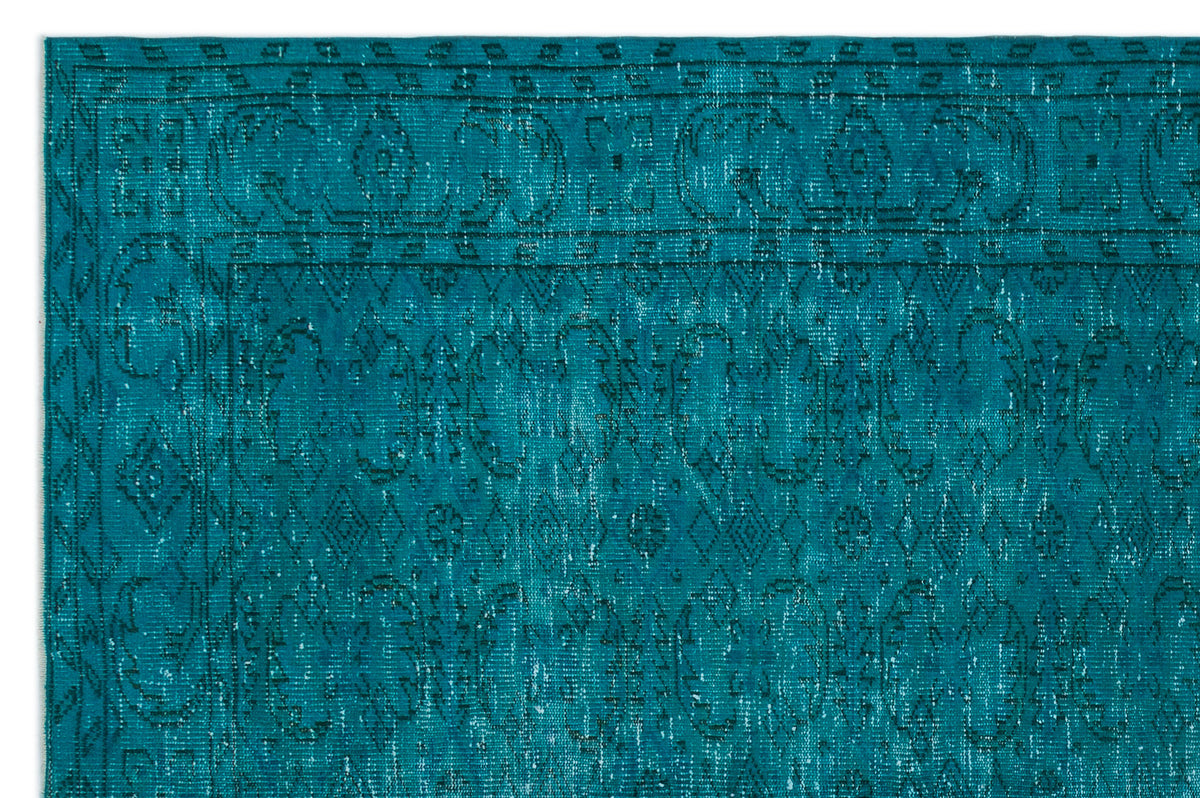 Teal distressed rug with a traditional Persian-style border and intricate geometric medallion pattern.