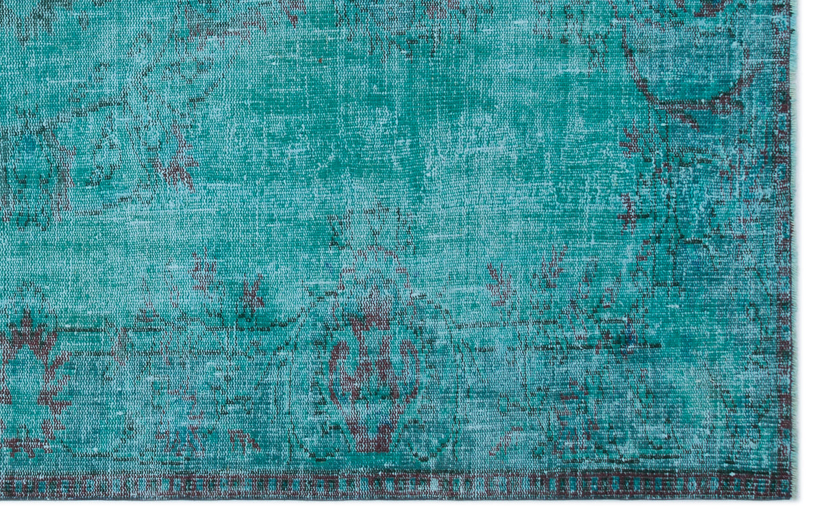 Teal and dark brown distressed rug with a faded traditional medallion pattern on a white background.