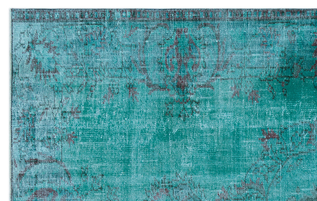 Teal and dark grey distressed rug with a faded traditional medallion pattern.