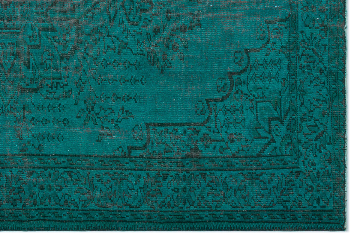 Teal and black rug with a distressed traditional medallion pattern and a detailed border.
