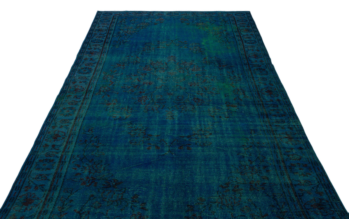 Deep blue and teal vintage-style rug with a distressed traditional medallion pattern on a white background.