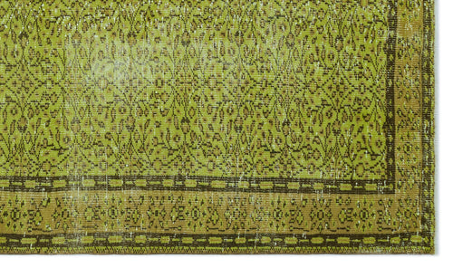 Load image 1 in gallery view. Chartreuse and brown vintage-style rug with a distressed floral pattern and a geometric border.