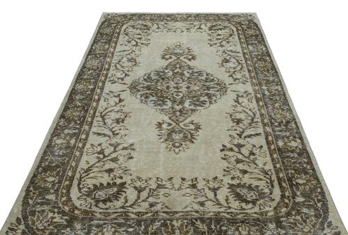 Load image 1 in gallery view. Beige and brown traditional rug with a central floral medallion and ornate border on a white background.