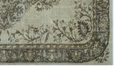 Load image 1 in gallery view. Beige and brown vintage-style rug with a distressed floral medallion pattern and a decorative border.