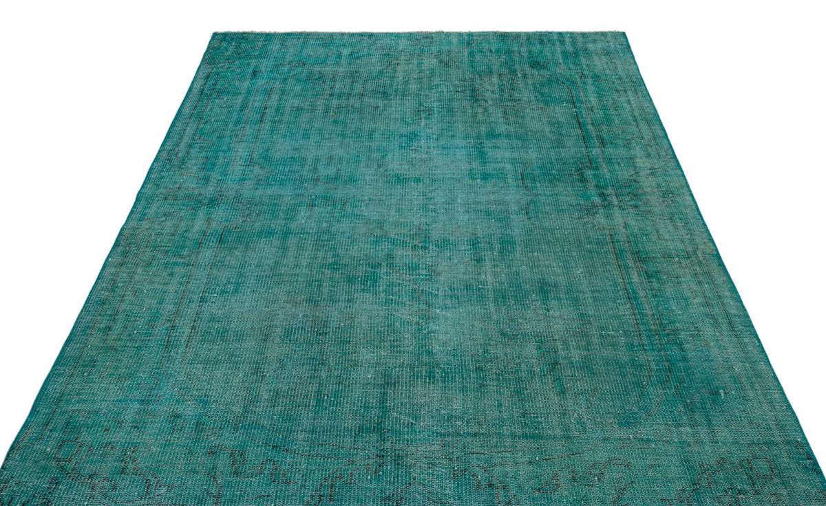 Teal distressed vintage-style rug with a faint, traditional medallion pattern on a white background.