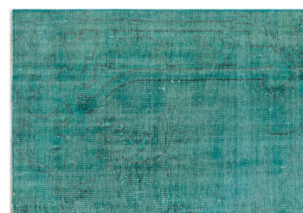 Teal vintage-style rug with a distressed, faded traditional medallion pattern and dark grey line detailing.