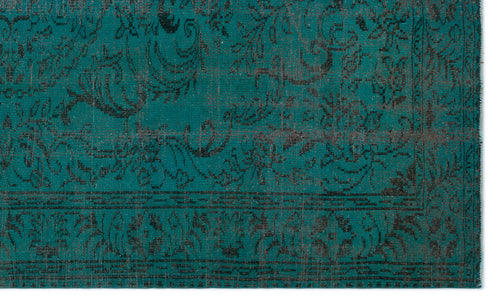 Load image 1 in gallery view. Teal rug with a black distressed floral pattern and a geometric border on a white background.