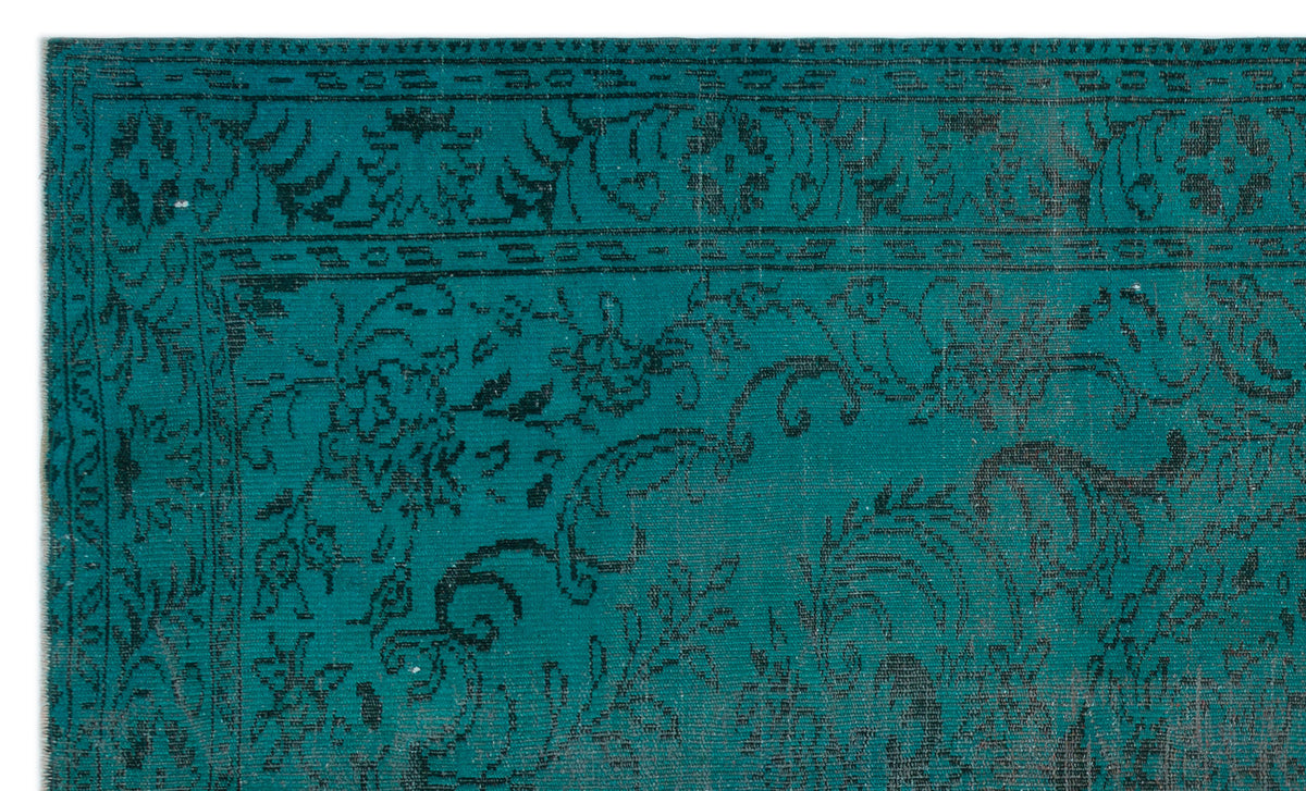 Teal rug with a black distressed traditional floral border and medallion pattern.