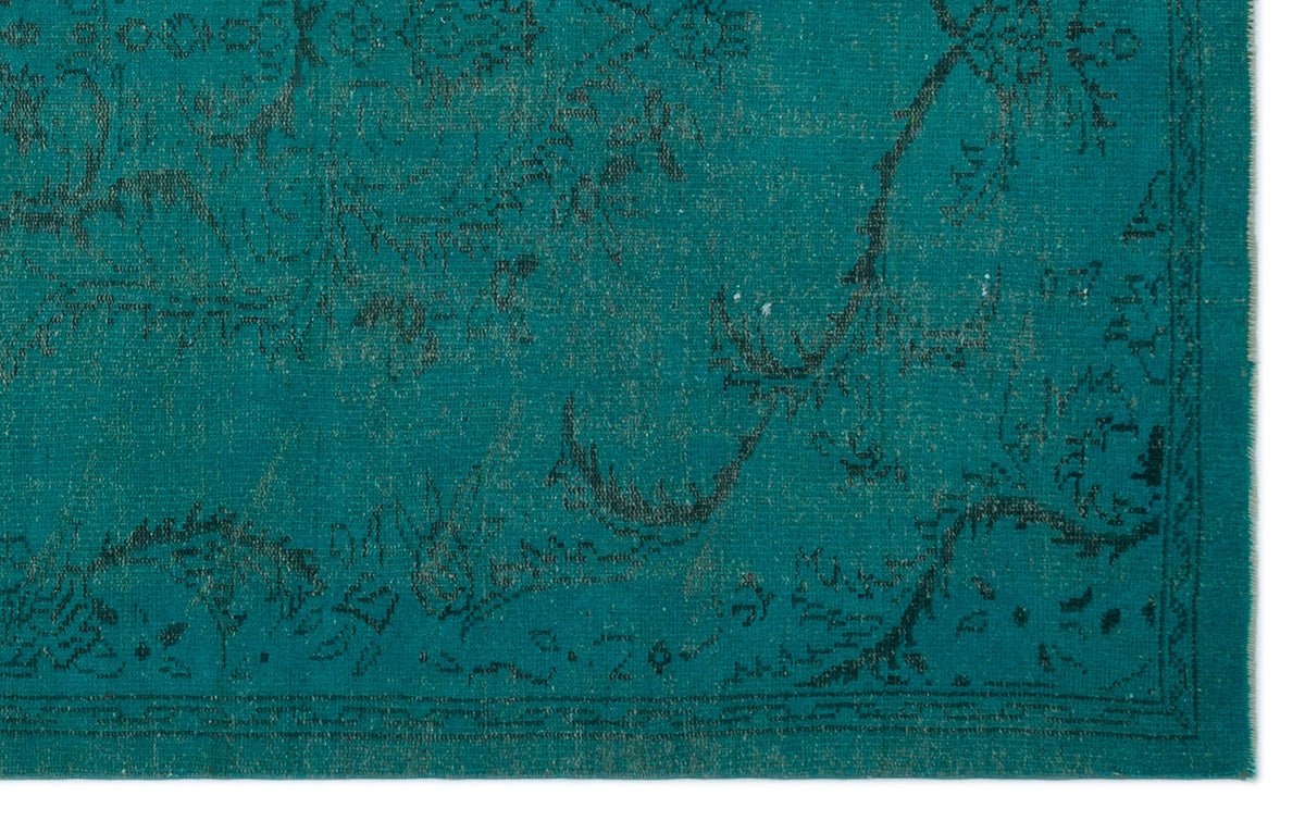 Teal rug with a distressed, dark charcoal traditional floral pattern and a bordered edge.