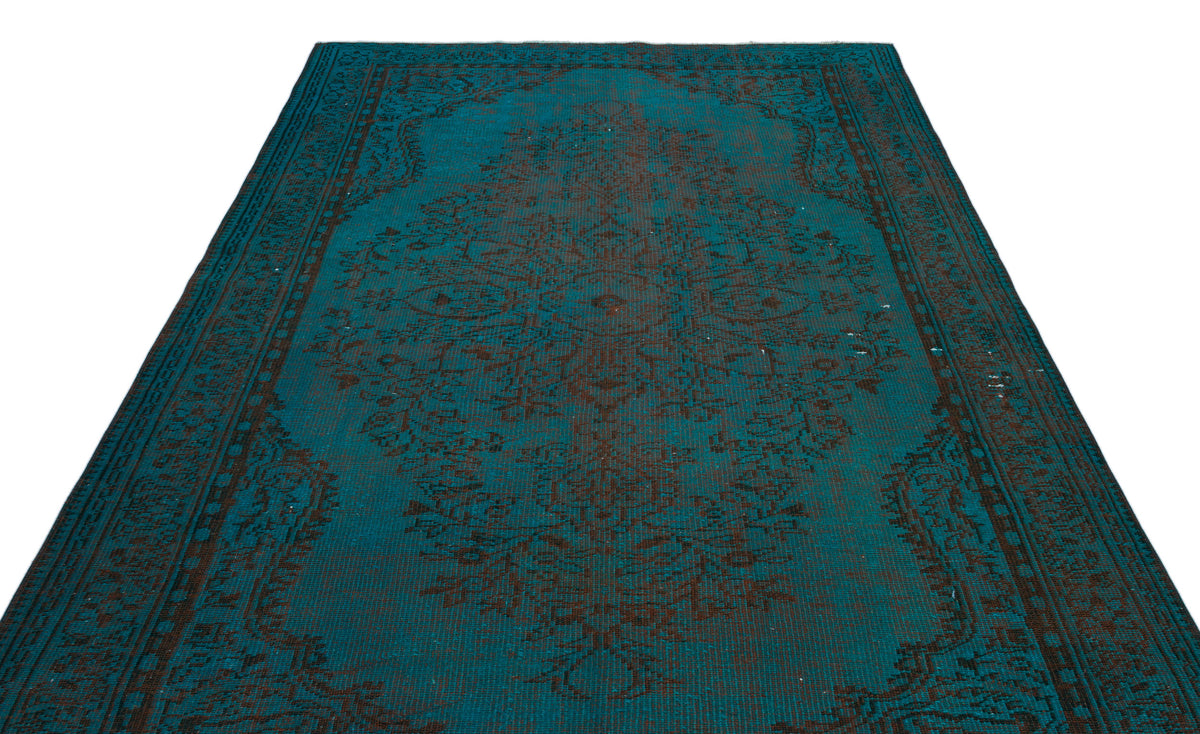 Teal and dark brown traditional rug with a central medallion and ornate border pattern on a white background.