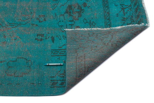 Load image 1 in gallery view. Teal and charcoal distressed vintage-style rug with a folded corner revealing the woven backing.