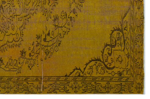 Load image 1 in gallery view. Mustard yellow rug with a dark brown distressed floral medallion pattern and a geometric border.