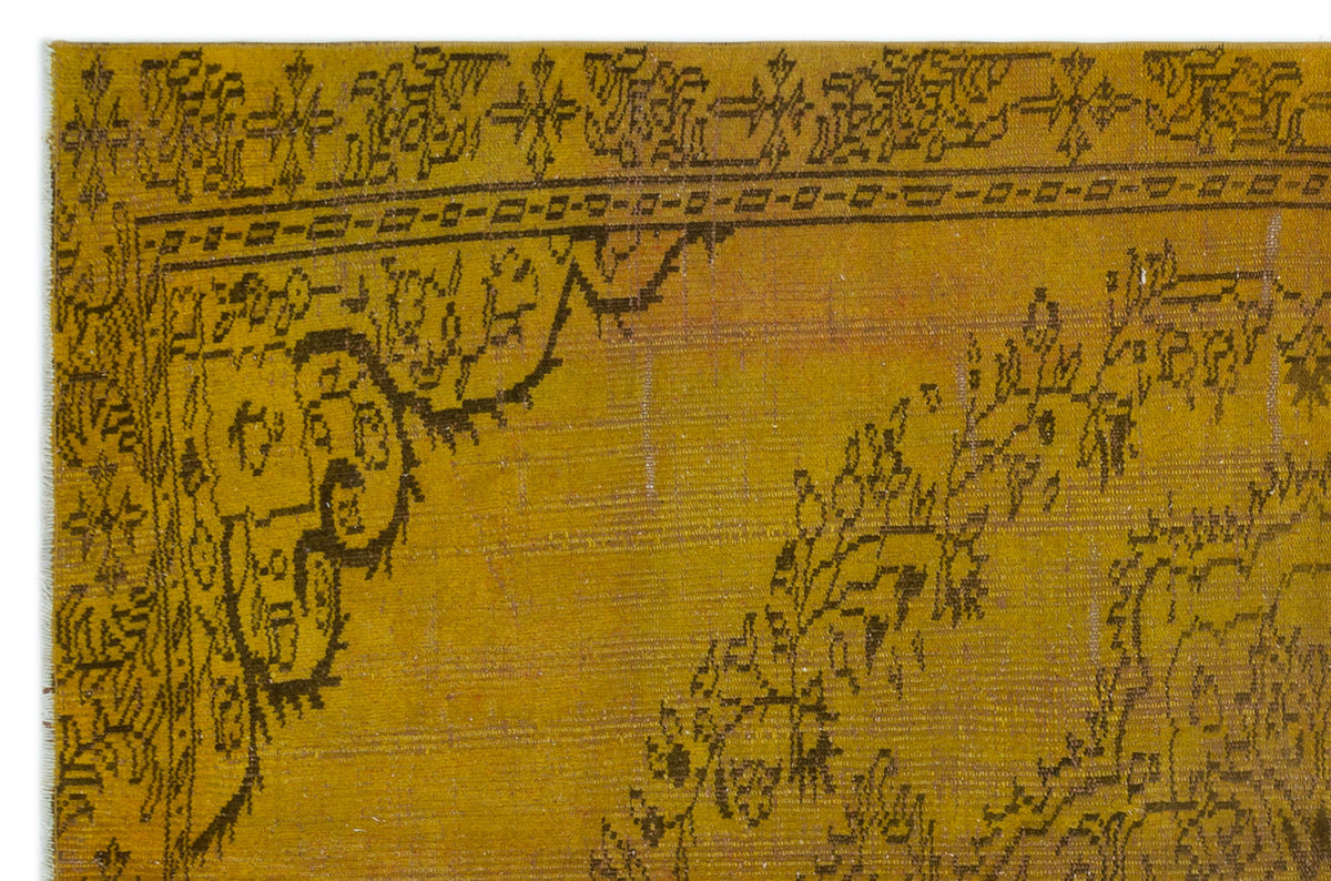 Mustard yellow rug with a dark brown traditional floral border and medallion corner detail.