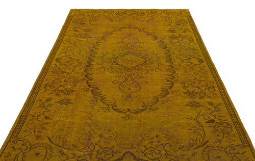 Load image 1 in gallery view. Mustard yellow vintage-style rug with a dark brown central floral medallion and ornate border on a white background.