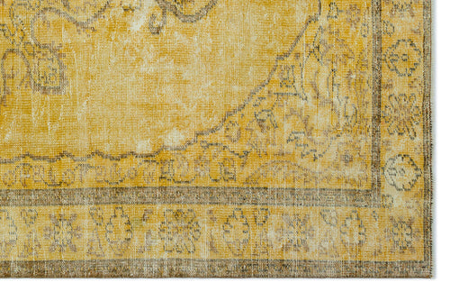 Load image 1 in gallery view. Mustard yellow and brown distressed rug with a traditional floral medallion pattern and a wide decorative border.
