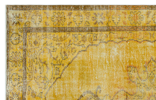 Load image 1 in gallery view. Distressed mustard yellow and brown rug with a traditional floral medallion border and faded center pattern.