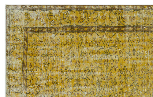 Load image 1 in gallery view. Mustard yellow and brown vintage-style rug with a distressed floral medallion pattern and a decorative border.
