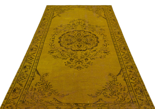 Load image 1 in gallery view. Mustard yellow runner rug with a dark brown central floral medallion and ornate border pattern on a white background.