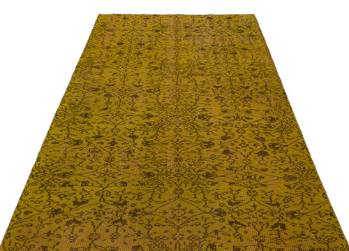 Load image 1 in gallery view. Mustard yellow vintage-style rug with a dark brown intricate floral medallion pattern on a white background.