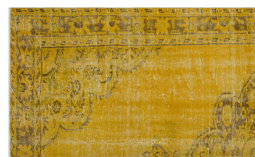 Load image 1 in gallery view. Mustard yellow vintage-style rug with a distressed, faded traditional medallion pattern in brown and olive green.