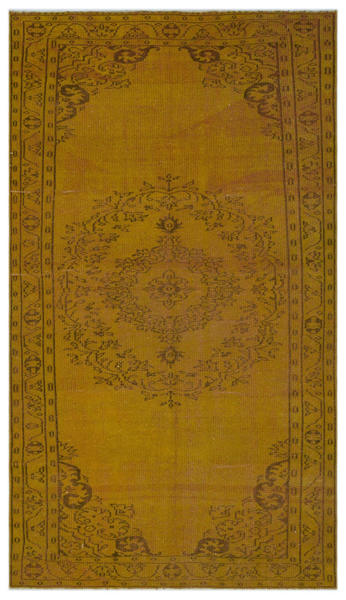 Load image 1 in gallery view. Mustard yellow vintage-style rug with a dark brown central floral medallion and a geometric border pattern.