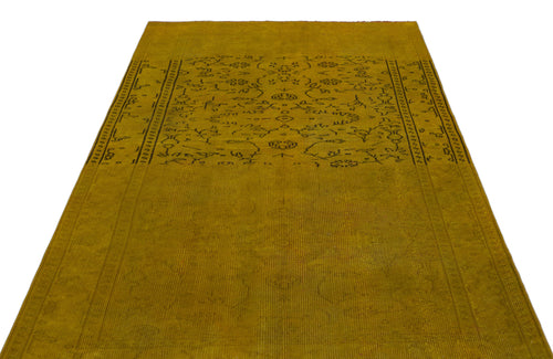 Load image 1 in gallery view. Mustard yellow vintage-style rug with a faded black floral medallion pattern and a decorative border.