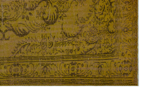 Load image 1 in gallery view. Olive green vintage-style rug with a dark brown distressed floral medallion pattern and a geometric border.