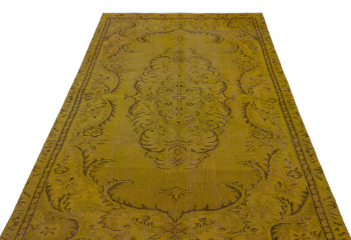 Load image 1 in gallery view. Mustard yellow vintage-style rug with a dark brown central floral medallion and ornate border on a white background.