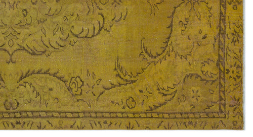 Load image 1 in gallery view. Mustard yellow vintage rug with a dark brown floral vine pattern and a decorative geometric border.