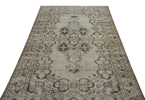 Load image 1 in gallery view. Beige and brown vintage-style rug with a central floral medallion and ornate border pattern on a white background.