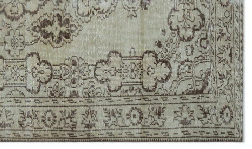 Load image 1 in gallery view. Beige and brown distressed rug with a traditional floral medallion pattern and a decorative border.