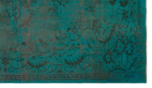 Load image 1 in gallery view. Teal rug with a distressed, dark charcoal floral medallion pattern and a fringed edge.