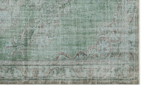 Load image 1 in gallery view. Sage green and cream distressed rug with a faded traditional medallion pattern and a bordered edge.