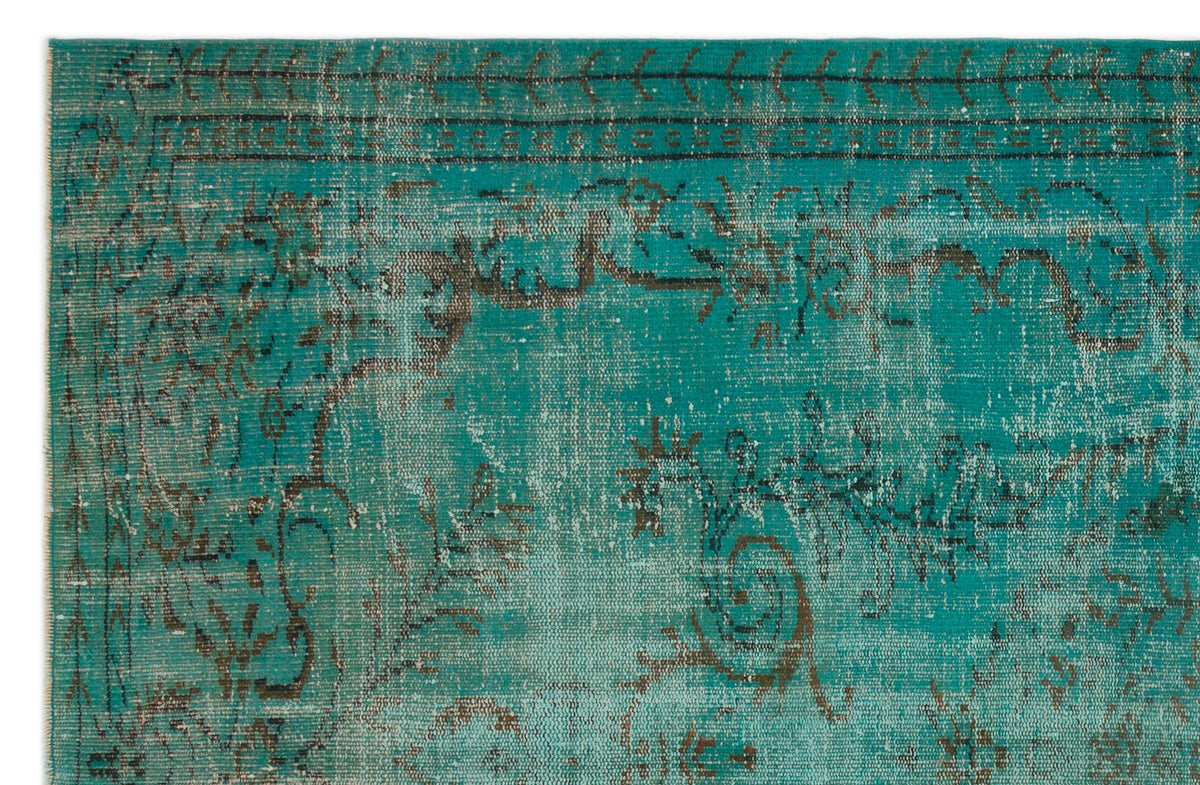 Teal and dark grey distressed rug with a faded traditional floral medallion pattern.