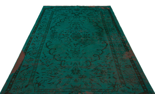 Load image 1 in gallery view. Emerald green vintage-style rug with a dark, distressed floral medallion pattern and a decorative border.
