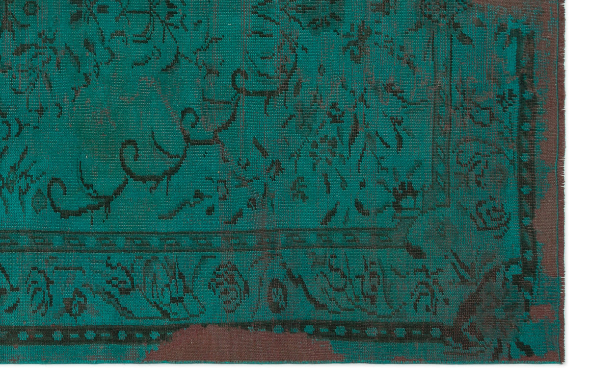 Teal and dark brown rug with a distressed, traditional floral medallion pattern and a bordered edge.