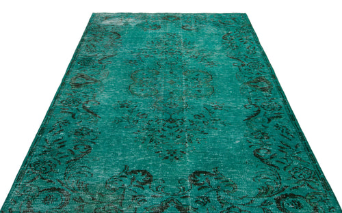Load image 1 in gallery view. Teal and black distressed vintage-style rug with a central floral medallion pattern on a white background.