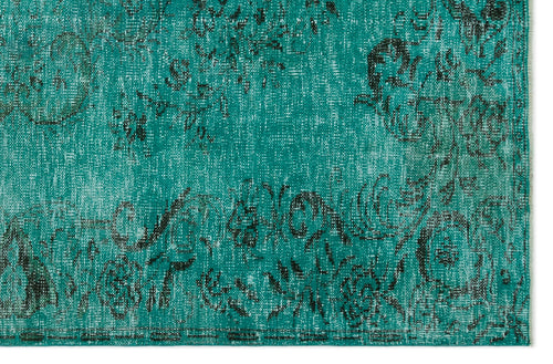 Load image 1 in gallery view. Teal and black distressed rug with a faded floral medallion pattern on a white background.