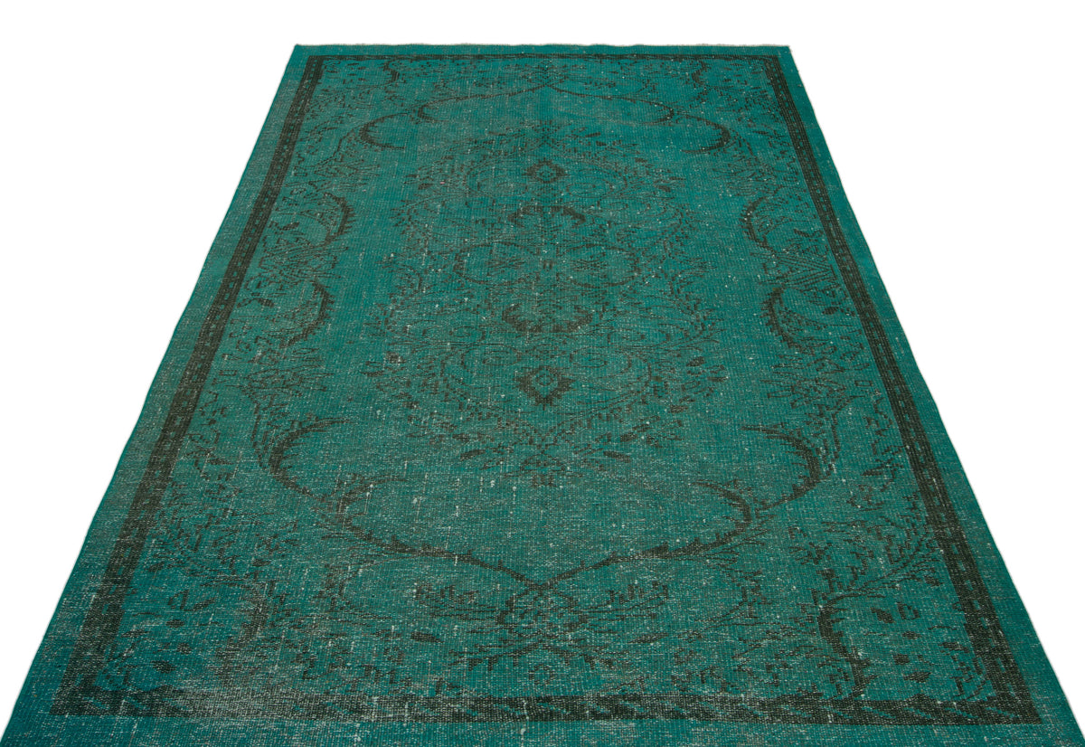 Teal and black distressed rug with a traditional central medallion and border pattern on a white background.