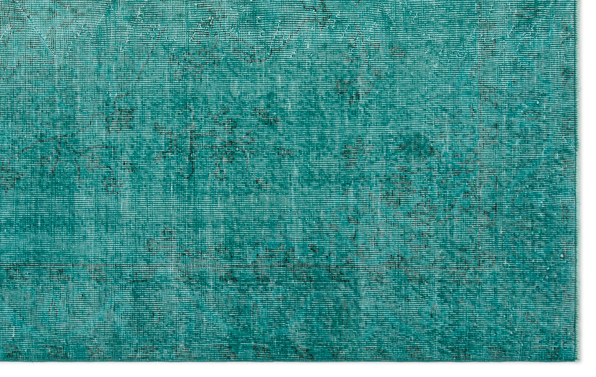 Teal distressed rug with a faded, traditional overdyed pattern on a white background.
