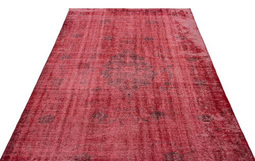 Load image 1 in gallery view. Distressed red vintage-style rug with a faded central medallion and dark grey ornamental patterns.