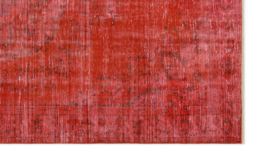 Load image 1 in gallery view. Red and pink distressed overdyed rug with a faded traditional medallion pattern.