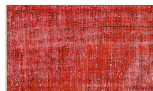 Load image 1 in gallery view. Red and pink distressed overdyed rug with a faded traditional border pattern.