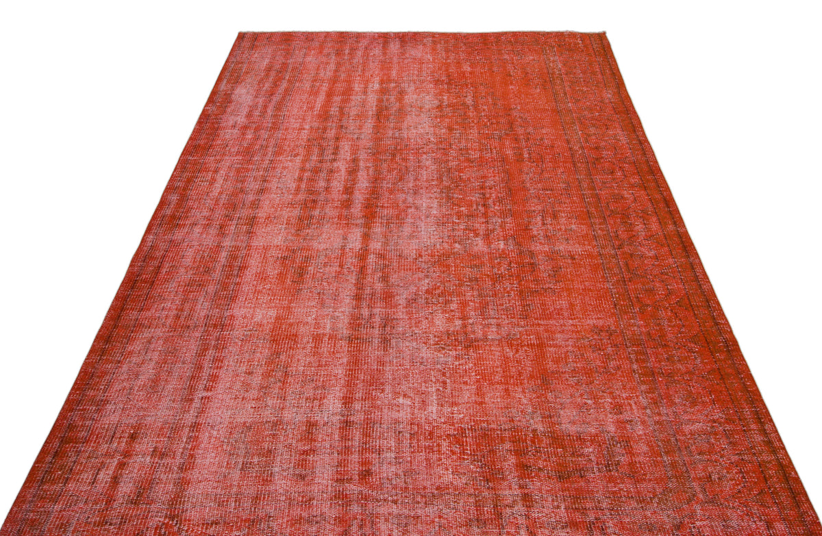 Distressed red vintage-style rug with a faded, overdyed texture and subtle border pattern on a white background.