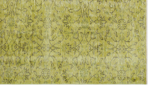 Load image 1 in gallery view. Chartreuse distressed rug with a faded, dark grey floral medallion pattern.